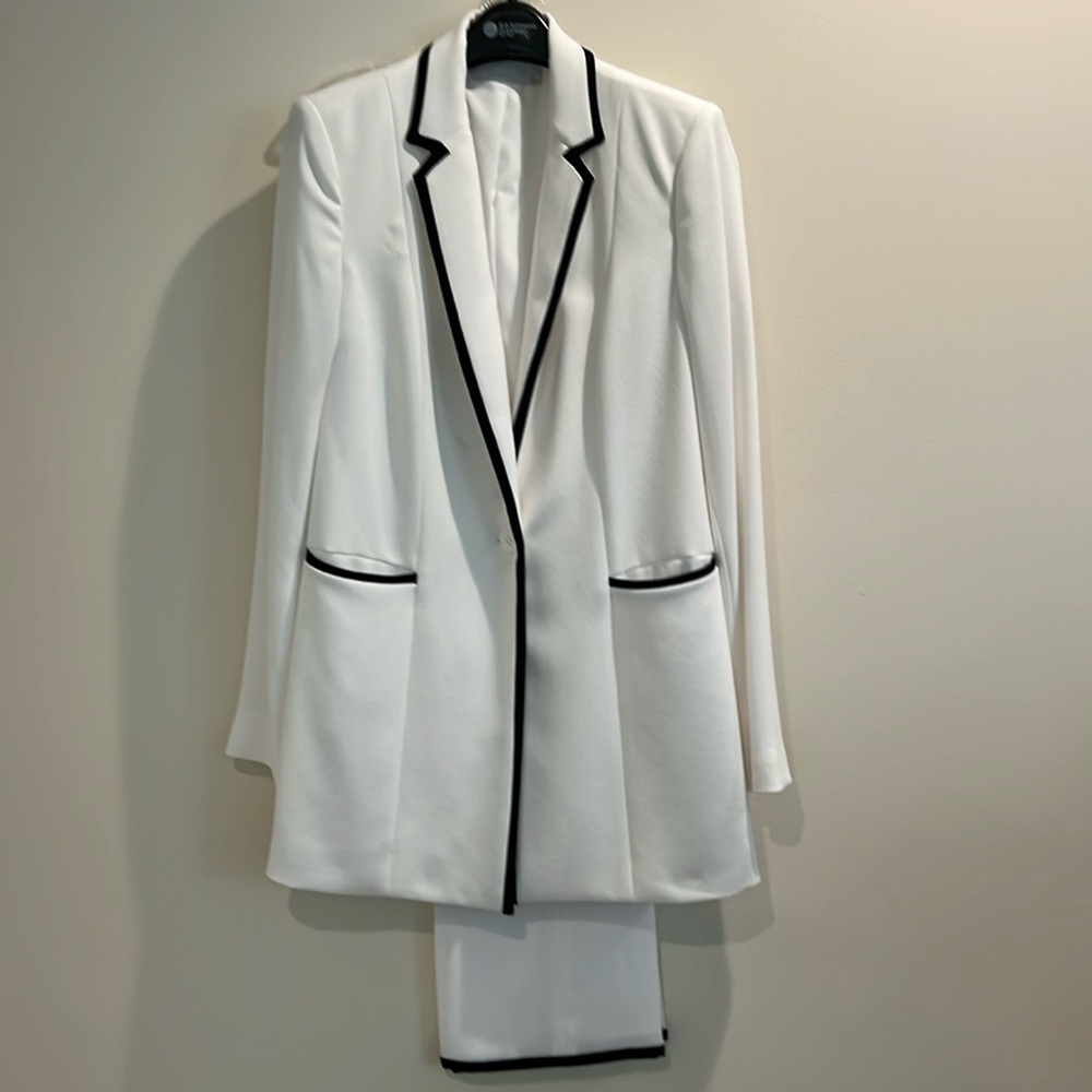White ladies pantsuit with black trim